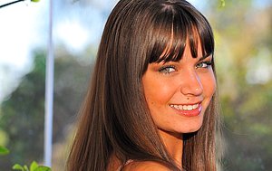 Adorable brunette with bangs posing in sexy see-through outfits