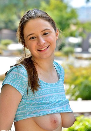 Playful young girl fingering her own slit and massaging her own boobs