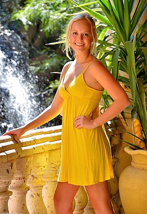 Yellow dress blonde riding a huge suction cup toy on the floor