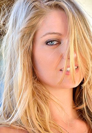 Blond-haired babe exposes her boobs and wet pussy in a hot gallery