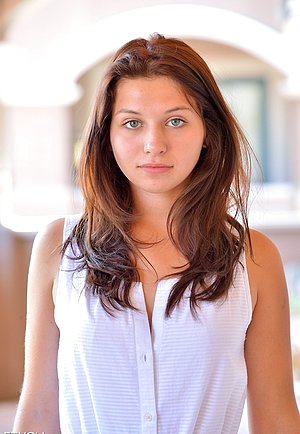Baby-faced beauty in white shows her boobs and ass for the camera