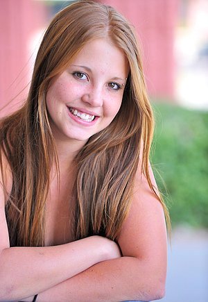 Brown-haired babe showing her cute face while picking toys for solo action