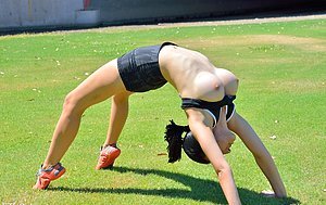 Big boobs brunette doing cartwheels and bridges in a public park