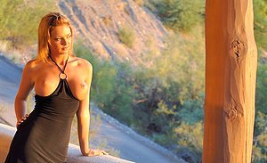 Leggy blonde showing her juicy hole next to a pretty fancy car