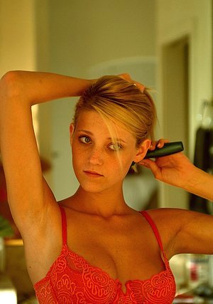 Superb blonde with a tight body shows her long legs and fucks a brush