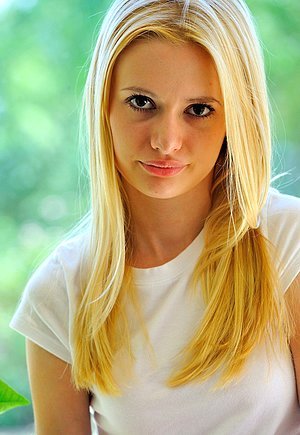 Slim blonde with a tiny waist shows her perfect nude body outdoors