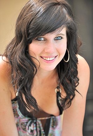 Effortlessly cute brunette with tattoos doing kicks and showing her pussy